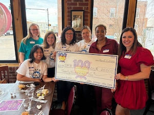 Members of the Columbus Air Force Base Spouses & Friends Club holding a check in Columbus, Ms., March 1, 2026.
