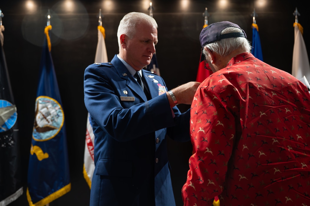 U.S. Air Force Col. Matthew Norton, 17th Training Wing commander, pins veterans during the Vietnam Veterans Ceremony.