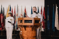 JOINT BASE PEARL HARBOR-HICKAM, Hawaii (March 12, 2026) - Cmdr. Daniel Jones, outgoing commanding officer of Virginia-class fast-attack submarine USS Hawaii (SSN 776), delivers remarks during the change of command ceremony for Hawaii at Sharkey Theater on Joint Base Pearl Harbor-Hickam, Hawaii, March 12, 2026. Hawaii is assigned to Submarine Squadron 1 and is capable of supporting various missions, including anti-submarine warfare, anti-surface ship warfare, strike warfare, special operations forces support, and intelligence, surveillance, and reconnaissance. (U.S. Navy photo by Mass Communication Specialist 2nd Class Nicholas Russell)