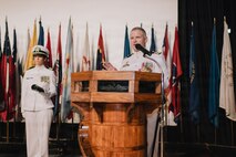 JOINT BASE PEARL HARBOR-HICKAM, Hawaii (March 12, 2026) - Cmdr. Daniel Jones, outgoing commanding officer of Virginia-class fast-attack submarine USS Hawaii (SSN 776), delivers remarks during the change of command ceremony for Hawaii at Sharkey Theater on Joint Base Pearl Harbor-Hickam, Hawaii, March 12, 2026. Hawaii is assigned to Submarine Squadron 1 and is capable of supporting various missions, including anti-submarine warfare, anti-surface ship warfare, strike warfare, special operations forces support, and intelligence, surveillance, and reconnaissance. (U.S. Navy photo by Mass Communication Specialist 2nd Class Nicholas Russell)
