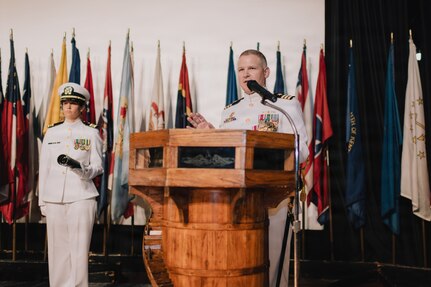 JOINT BASE PEARL HARBOR-HICKAM, Hawaii (March 12, 2026) - Cmdr. Daniel Jones, outgoing commanding officer of Virginia-class fast-attack submarine USS Hawaii (SSN 776), delivers remarks during the change of command ceremony for Hawaii at Sharkey Theater on Joint Base Pearl Harbor-Hickam, Hawaii, March 12, 2026. Hawaii is assigned to Submarine Squadron 1 and is capable of supporting various missions, including anti-submarine warfare, anti-surface ship warfare, strike warfare, special operations forces support, and intelligence, surveillance, and reconnaissance. (U.S. Navy photo by Mass Communication Specialist 2nd Class Nicholas Russell)