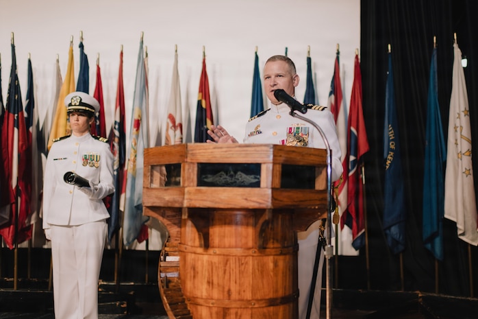 JOINT BASE PEARL HARBOR-HICKAM, Hawaii (March 12, 2026) - Cmdr. Daniel Jones, outgoing commanding officer of Virginia-class fast-attack submarine USS Hawaii (SSN 776), delivers remarks during the change of command ceremony for Hawaii at Sharkey Theater on Joint Base Pearl Harbor-Hickam, Hawaii, March 12, 2026. Hawaii is assigned to Submarine Squadron 1 and is capable of supporting various missions, including anti-submarine warfare, anti-surface ship warfare, strike warfare, special operations forces support, and intelligence, surveillance, and reconnaissance. (U.S. Navy photo by Mass Communication Specialist 2nd Class Nicholas Russell)
