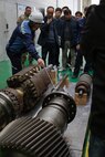 U.S. Army Chief Warrant Officer 5 Robert Henrikson, 2nd Infantry Division (2ID), Chief Warrant Officer 2 Eric Duddy, 194th Division Sustainment Battalion, and Maj. James Buensuceso, 2ID, are guided by South Korea Navy service members through a navy shipyard for close interaction with 3D printers used for their equipment, Changwon, South Korea, March 25, 2026.