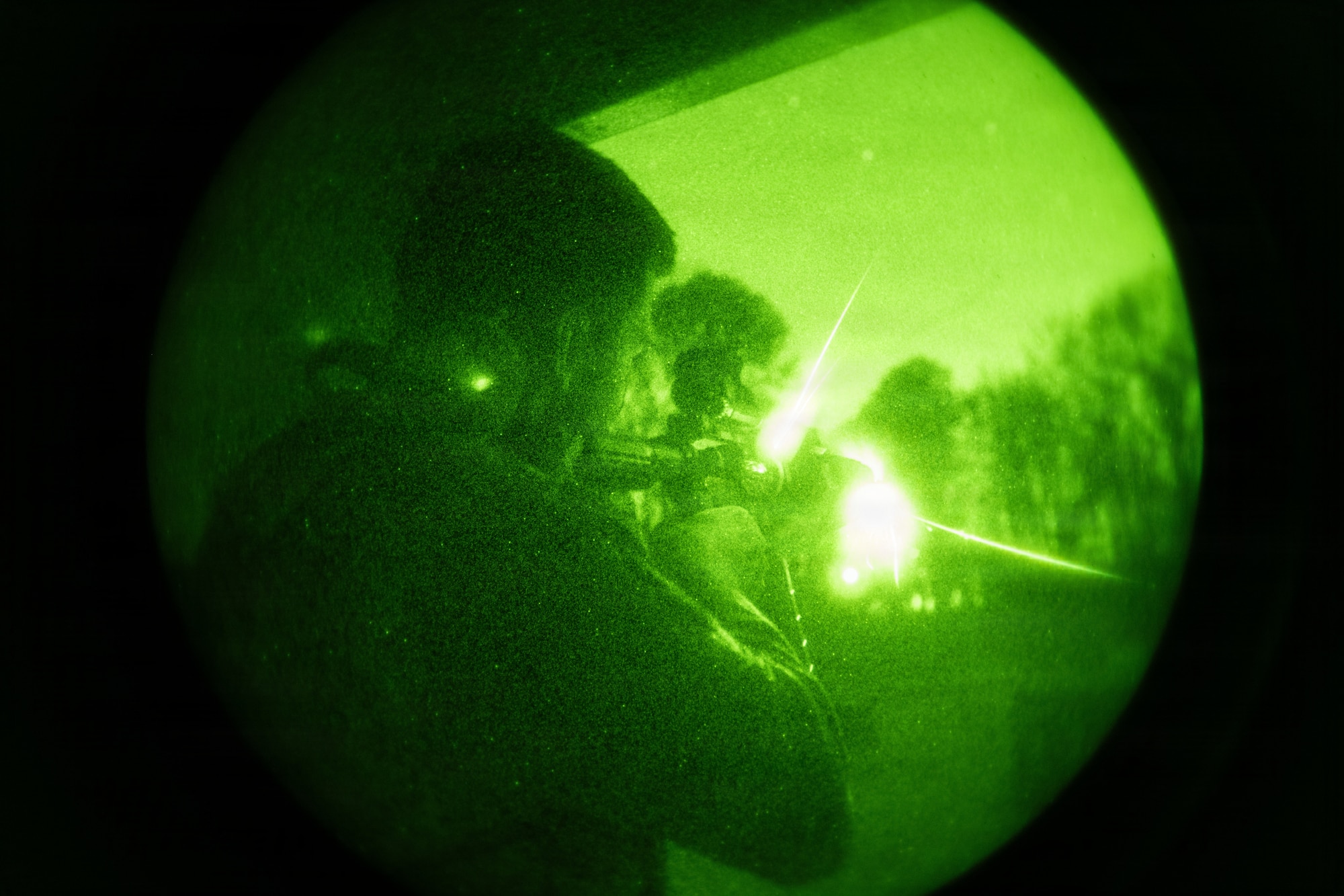 Airmen working with K9 military Working Dogs in night vision