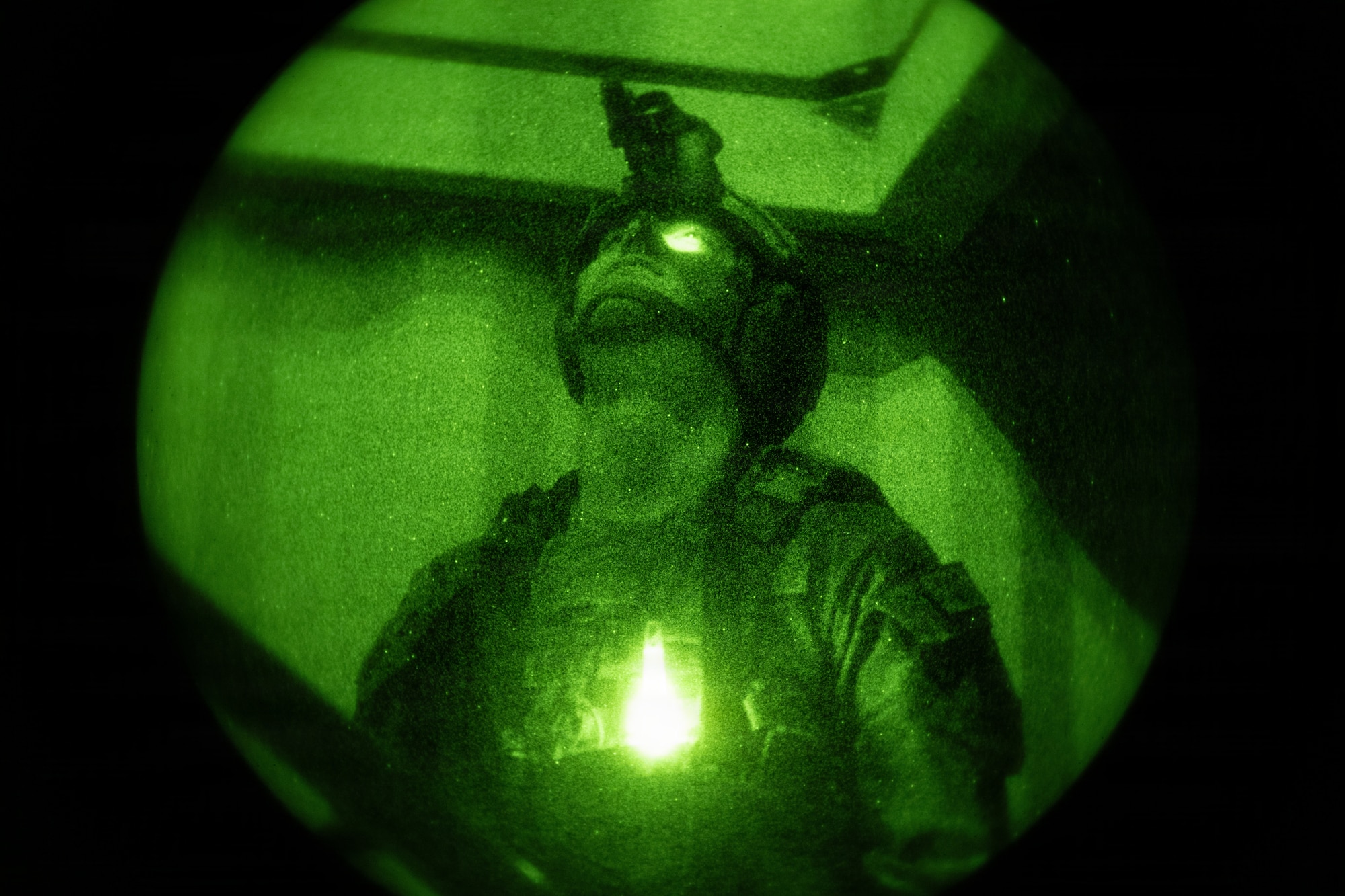 Airmen working with K9 military Working Dogs in night vision