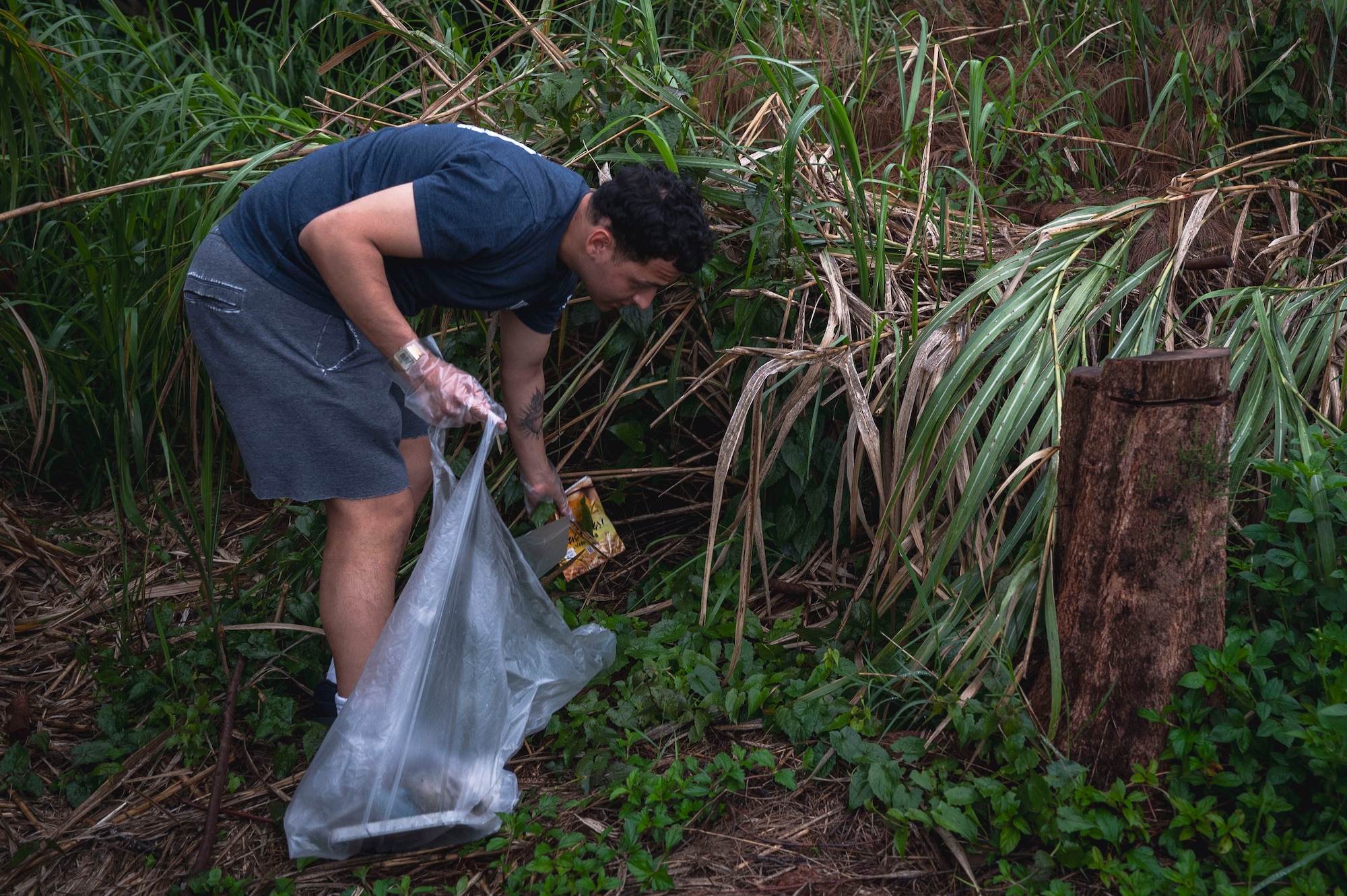 U.S. Air Force Airman 1st Class Jonathan Villegas-Ochoa, 718th Force Support Squadron fitness apprentice, picks up trash in Chatan Town, Okinawa, Japan, April 1, 2026.