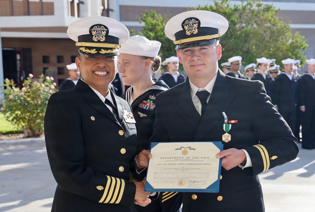 Capt. Janiese Cleckley (left), commanding officer of Navy Medicine Readiness and Training Command Twentynine Palms, presents a Navy and Marine Corps Commendation Medal to Lt. Andrew Crane during a command award ceremony at Robert E. Bush Naval Hospital, Oct. 3, 2025. Crane was later recognized with the Navy Psychology-sponsored CDR Erin Simmons Award for his efforts to expand access to mental health care and strengthen warfighter readiness. (Courtesy photo).