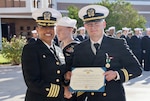 Capt. Janiese Cleckley (left), commanding officer of Navy Medicine Readiness and Training Command Twentynine Palms, presents a Navy and Marine Corps Commendation Medal to Lt. Andrew Crane during a command award ceremony at Robert E. Bush Naval Hospital, Oct. 3, 2025. Crane was later recognized with the Navy Psychology-sponsored CDR Erin Simmons Award for his efforts to expand access to mental health care and strengthen warfighter readiness. (Courtesy photo).