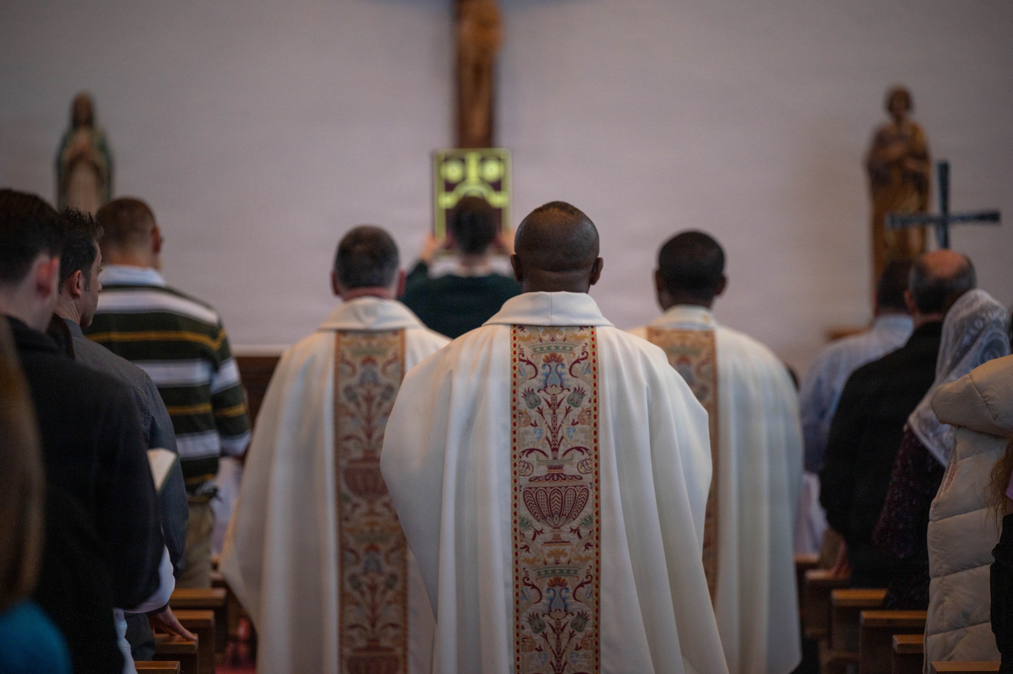 Chaplains assigned to the 86th Airlift Wing walk down the aisle during a Holy Thursday mass at the Northside Chapel on Ramstein Air Base, Germany, April 2, 2026.