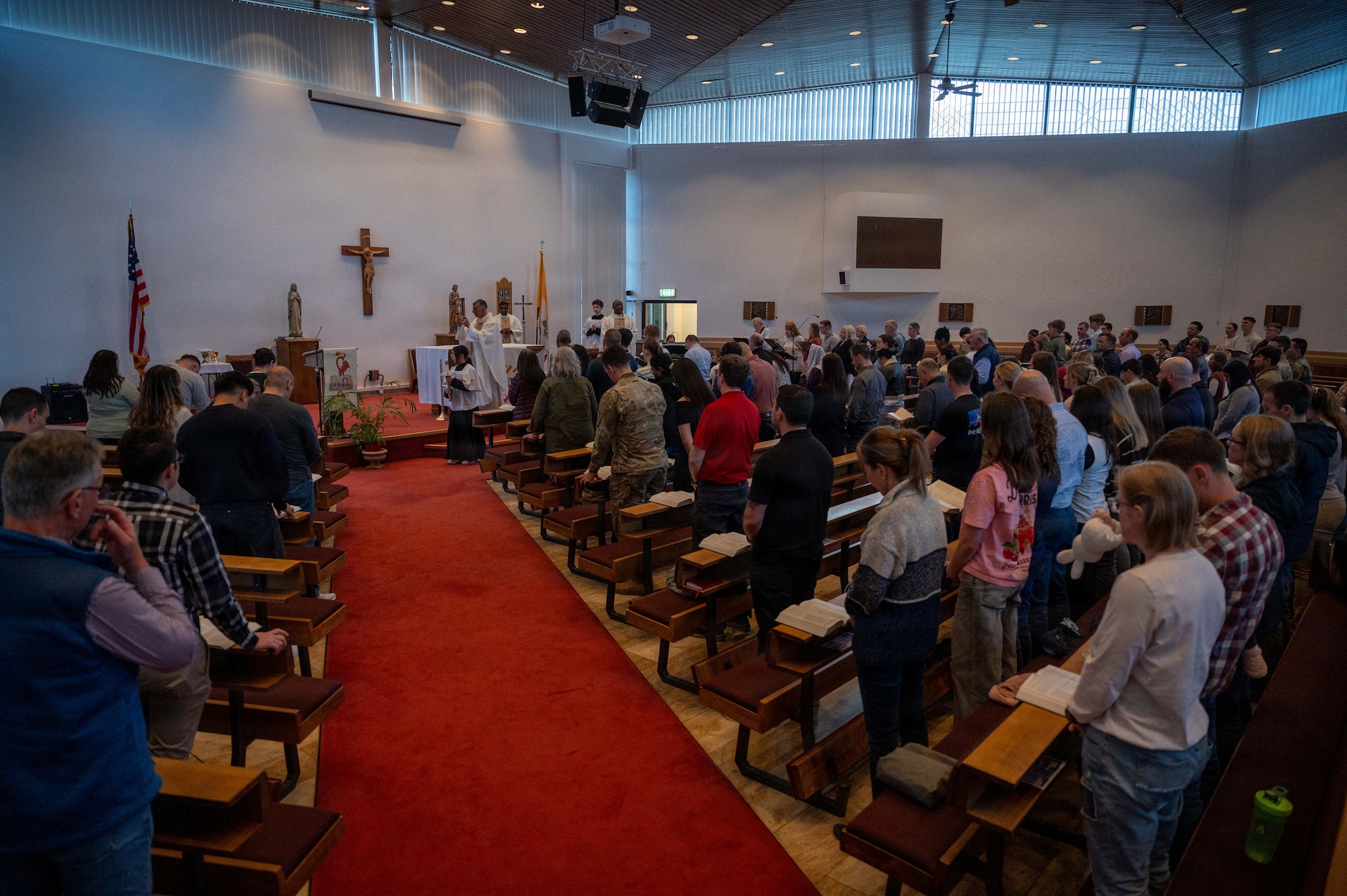 A congregation stands in prayer at the Northside Chapel during a Holy Thursday mass on Ramstein Air Base, Germany, April 2, 2026.