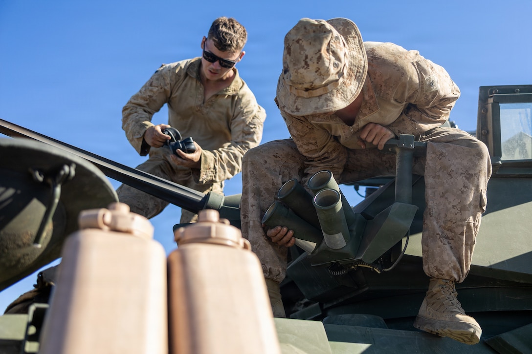 U.S. Marine Corps Sgt. Alexander Taylor, light armored vehicle gunner, left and Lance Cpl. Alex Schmidt, a light armored reconnaissance Marine, right, both with 2d Light Armored Reconnaissance Battalion, 2d Marine Division, prep their light armored vehicle for the light armored vehicle live-fire range event during the 2026 Bushmaster Competition, Camp Pendleton, California, March 27, 2026. This year, hosted by 4th Light Armored Reconnaissance, 4th Marine Division, the friendly competition gathers Light Armored Vehicle crews from across the U.S. Marine Corps, Australia and New Zealand to test their tactical and technical skills. (U.S. Marine Corps photo by Sgt. Aaron TorresLemus)