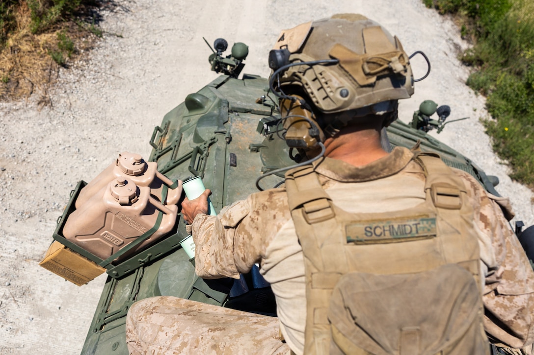 U.S. Marine Corps Lance Cpl. Alex Schmidt, a light armored reconnaissance Marine with 2d Light Armored Reconnaissance Battalion, 2d Marine Division, loads the light armored vehicle 25 with smoke grenades for the light armored vehicle live-fire range event during the 2026 Bushmaster Competition, Camp Pendleton, California, March 27, 2026. This year, hosted by 4th Light Armored Reconnaissance, 4th Marine Division, the friendly competition gathers Light Armored Vehicle crews from across the U.S. Marine Corps, Australia and New Zealand to test their tactical and technical skills. (U.S. Marine Corps photo by Sgt. Aaron TorresLemus)