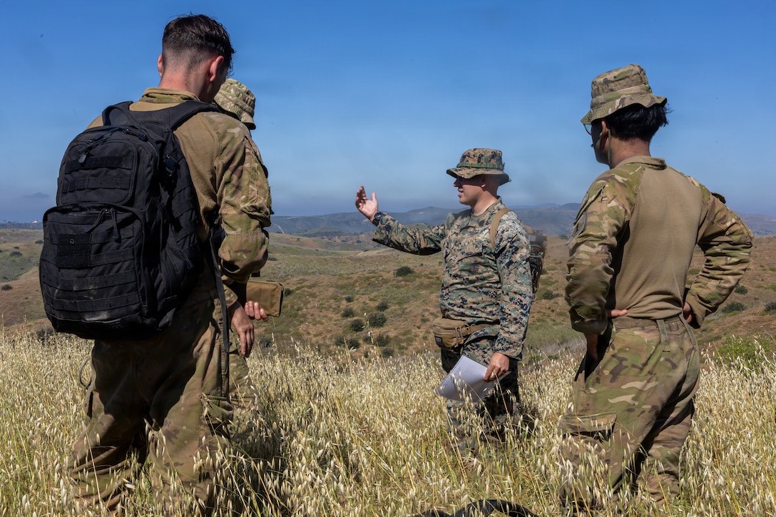 U.S. Navy Hospital Corpsman 3rd Class Tyler Himmer, center, with 2d Light Armored Reconnaissance, 2d Marine Division, prepares soldiers with 1st Battalion, Royal New Zealand Infantry Regiment, for an evaluated tactical combat casualty care event during the 2026 Bushmaster Competition, Camp Pendleton, California, March 25, 2026. This year, hosted by 4th Light Armored Reconnaissance, 4th Marine Division, the friendly competition gathers Light Armored Vehicle crews from across the U.S. Marine Corps, Australia and New Zealand to test their tactical and technical skills. (U.S. Marine Corps photo by Sgt. Aaron TorresLemus)
