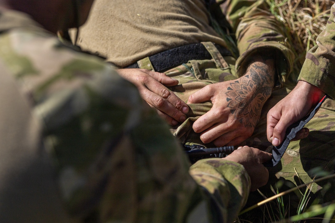Royal New Zealand Lance Cpl. Firzi Daud, applies a tourniquet on Lance Cpl. Josh Latham, both soldiers with 1st Battalion, Royal New Zealand Infantry Regiment, for an evaluated tactical combat casualty care event during the 2026 Bushmaster Competition, Camp Pendleton, California, March 25, 2026. This year, hosted by 4th Light Armored Reconnaissance, 4th Marine Division, the friendly competition gathers Light Armored Vehicle crews from across the U.S. Marine Corps, Australia and New Zealand to test their tactical and technical skills. (U.S. Marine Corps photo by Sgt. Aaron TorresLemus)