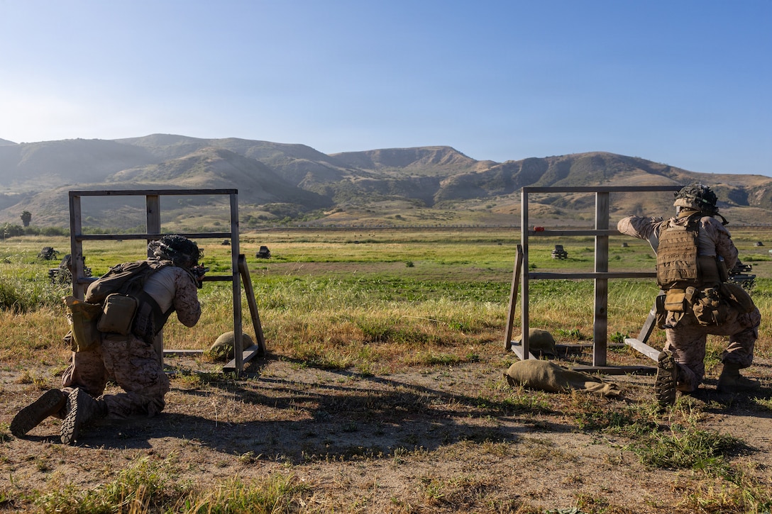 U.S. Marine Corps Cpl. Nicholas Bodily, a light armored vehicle driver, left and Lance Cpl. Kevin Zeron, a motor transport operator, right, both with 4th Light Armored Reconnaissance, 4th Marine Division, shoot down range during the rifle skill range portion event during the 2026 Bushmaster Competition, Camp Pendleton, California, March 25, 2026. This year, hosted by 4th Light Armored Reconnaissance, 4th Marine Division, the friendly competition gathers Light Armored Vehicle crews from across the U.S. Marine Corps, Australia and New Zealand to test their tactical and technical skills. (U.S. Marine Corps photo by Sgt. Aaron TorresLemus)