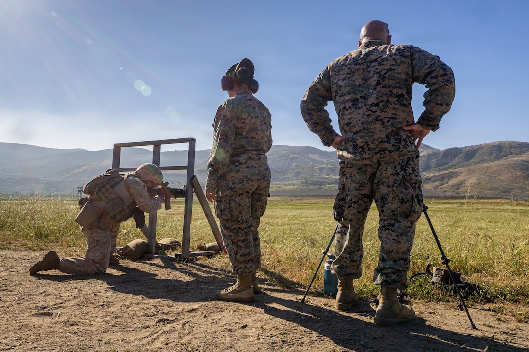 U.S. Marine Corps First Sgt. Kevin Robinson, company First Sgt, right and Cpl. Perez Priscilla, a range coach, middle, with 4th Light Armored Reconnaissance (LAR), 4th Marine Division evaluate Gunnery Sgt. Carlos Nunez, a platoon Sgt., left, with 4th LAR during the rifle skill range portion event during the 2026 Bushmaster Competition, Camp Pendleton, California, March 25, 2026. This year, hosted by 4th Light Armored Reconnaissance, 4th Marine Division, the friendly competition gathers Light Armored Vehicle crews from across the U.S. Marine Corps, Australia and New Zealand to test their tactical and technical skills. (U.S. Marine Corps photo by Sgt. Aaron TorresLemus)