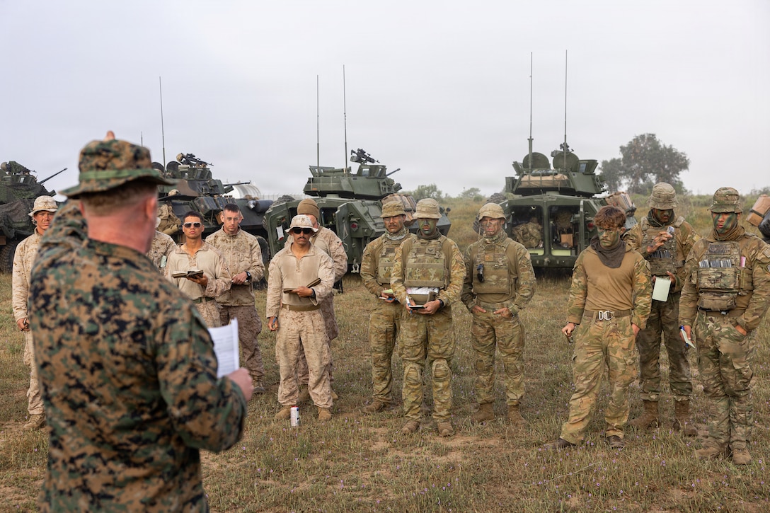 U.S. Marine Corps Master Gunnery Sgt. Thomas Stewart, operations chief with 4th Light Armored Reconnaissance, 4th Marine Division provides a safety brief to Marines and partnered service members prior to the mounted land navigation event during the 2026 Bushmaster Competition, Camp Pendleton, California, March 26, 2026. This year, hosted by 4th Light Armored Reconnaissance, 4th Marine Division, the friendly competition gathers Light Armored Vehicle crews from across the U.S. Marine Corps, Australia and New Zealand to test their tactical and technical skills. (U.S. Marine Corps photo by Sgt. Aaron TorresLemus)