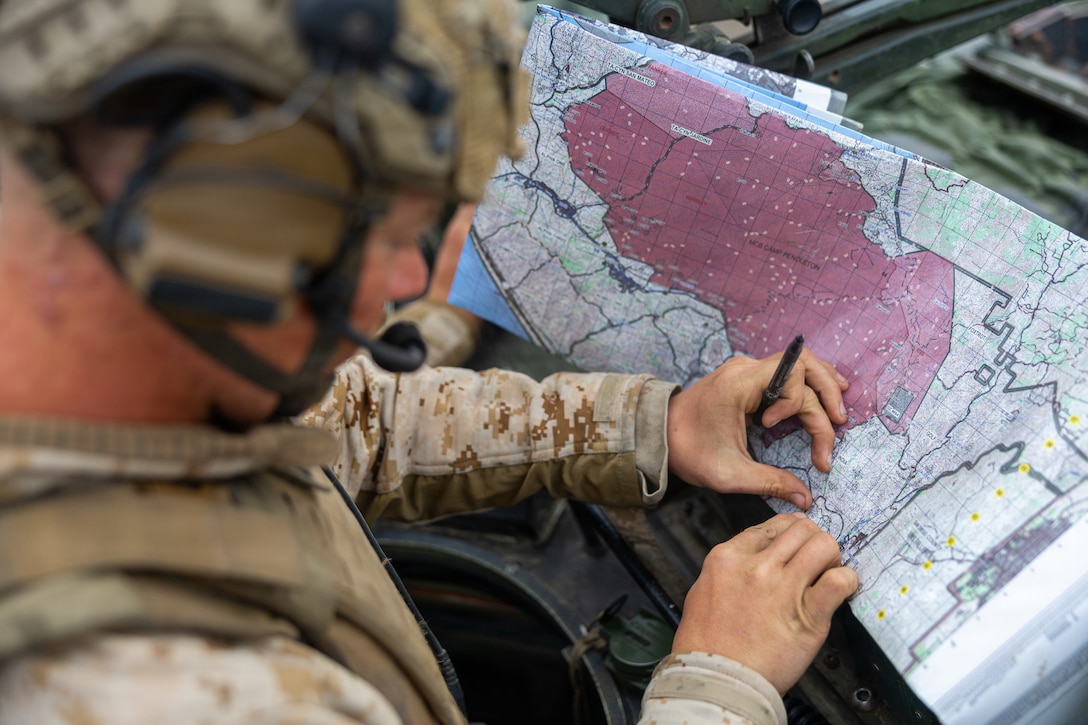 U.S. Marine Corps Sgt. Nathaniel Schneiders, a Light Armored Reconnaissance Marine with 3d Light Armored Reconnaissance, 1st Marine Division, plots grid points for the mounted land navigation event during the 2026 Bushmaster Competition, Camp Pendleton, California, March 26, 2026. This year, hosted by 4th Light Armored Reconnaissance, 4th Marine Division, the friendly competition gathers Light Armored Vehicle crews from across the U.S. Marine Corps, Australia and New Zealand to test their tactical and technical skills. (U.S. Marine Corps photo by Sgt. Aaron TorresLemus)