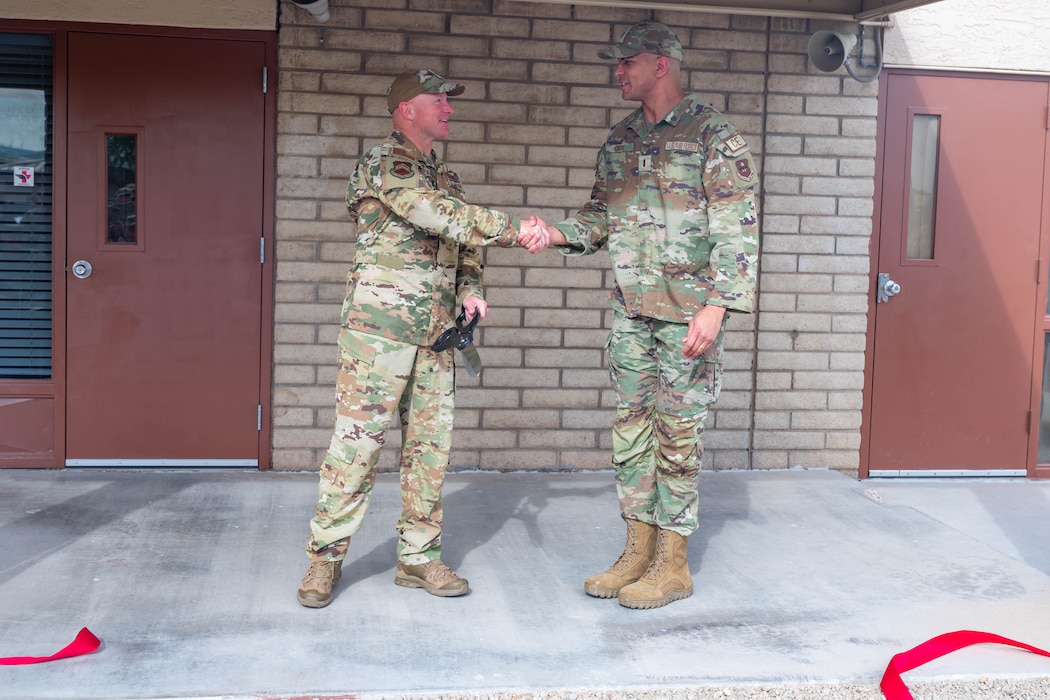 U.S. Air Force Brig. Gen. David Berkland (left), 56th Fighter Wing commander, and 2nd Lt. Nigel Cook (right), 56th Civil Engineer Squadron project programmer, shake hands during the opening of Fire Station 2, March 31, 2026, at Luke Air Force Base, Arizona.