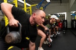 U.S. Air Force Maj. Ryan Hartman, 16th Air Force (Air Forces Cyber) intelligence officer, performs a kettlebell row during a “Motivation Through Fitness” class at Warhawk Fitness Center, Joint Base San Antonio-Lackland, Texas, Feb. 23, 2026. The class promotes physical readiness and resilience supporting War Department missions. (U.S. Air Force photo by Marcus Robins)