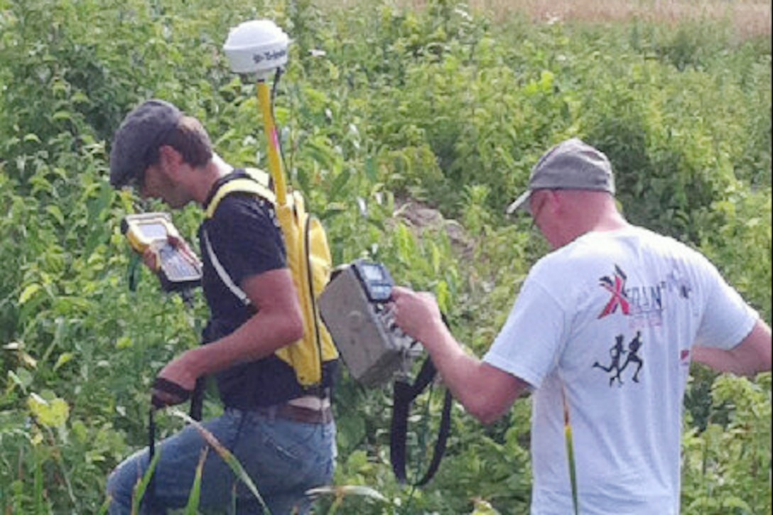 Health physicists conduct radiation surveys at a FUSRAP site. (Courtesy Photo)