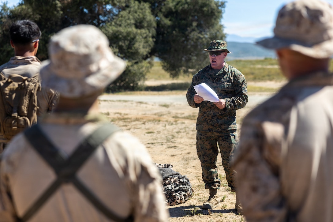 U.S. Marine Corps Master Gunnery Sgt. Thomas Stewart, operations chief with 4th Light Armored Reconnaissance, 4th Marine Division provides a safety brief to Marines and partnered service members prior to the cover and concealment event during the 2026 Bushmaster Competition, Camp Pendleton, California, March 26, 2026. This year, hosted by 4th Light Armored Reconnaissance, 4th Marine Division, the friendly competition gathers Light Armored Vehicle crews from across the U.S. Marine Corps, Australia and New Zealand to test their tactical and technical skills. (U.S. Marine Corps photo by Sgt. Aaron TorresLemus)