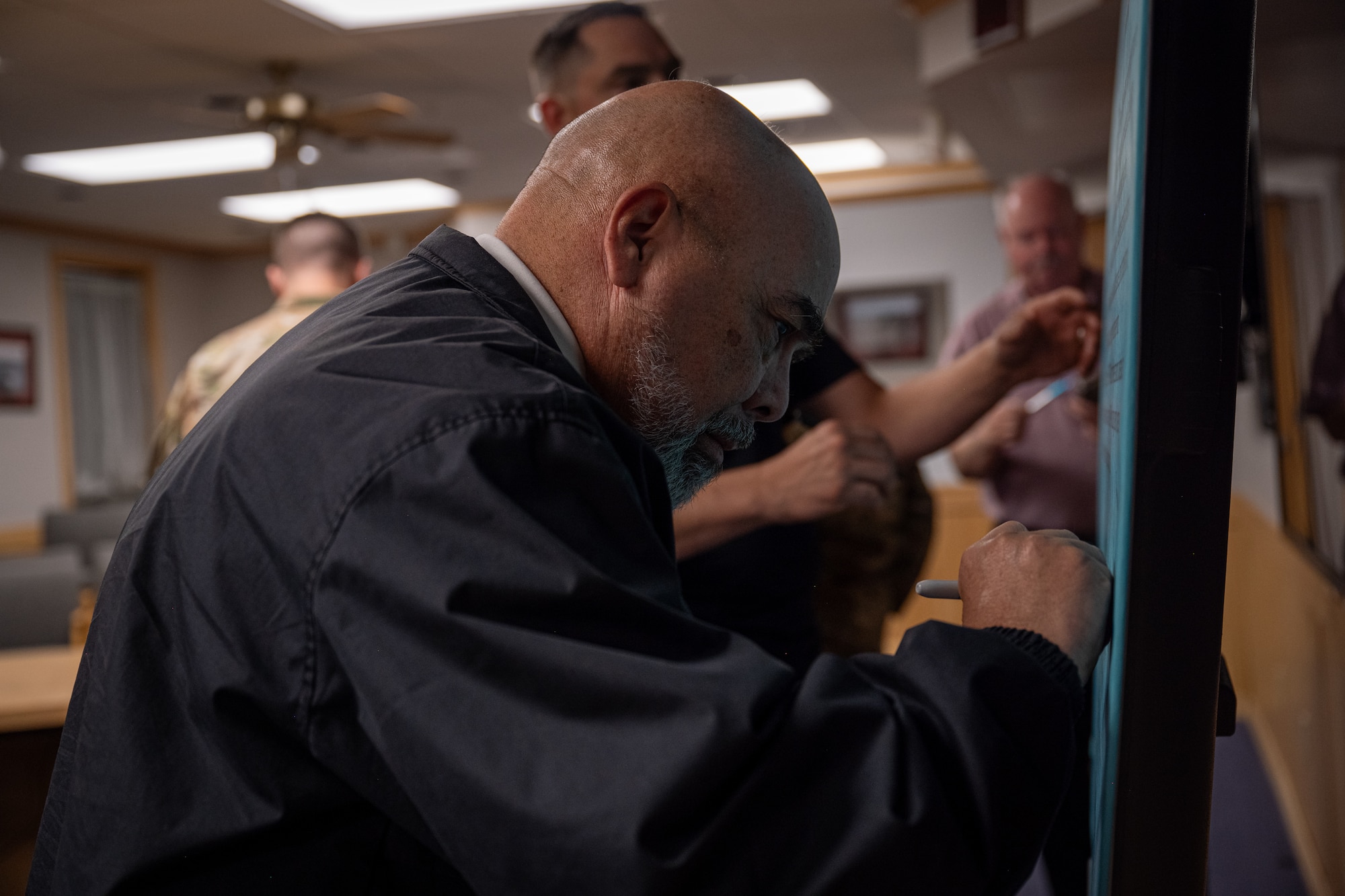 Carlos Duchesne, 7th Bomb Wing Integrated Resilience Office prevention and response director, signs the Sexual Assault Awareness Month proclamation at Dyess Air Force Base, Texas, April 1, 2026. The IRO mission is to reduce incidences of interpersonal and self-directed violence by building and sustaining a resilient community that fosters mental, physical, social and spiritual fitness. (U.S. Air Force photo by Airman 1st Class Adrien Tran)