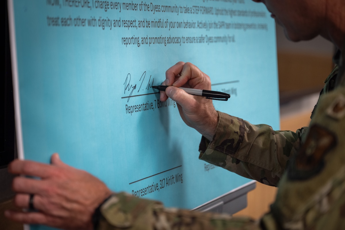 U.S. Air Force Col. Ryan Stallsworth, 7th Bomb Wing deputy commander, signs the Sexual Assault Awareness proclamation at Dyess Air Force Base, Texas, April 1, 2026. Event attendees were invited to add their signatures to the proclamation to demonstrate their support for SAAM. (U.S. Air Force photo by Airman 1st Class Adrien Tran)
