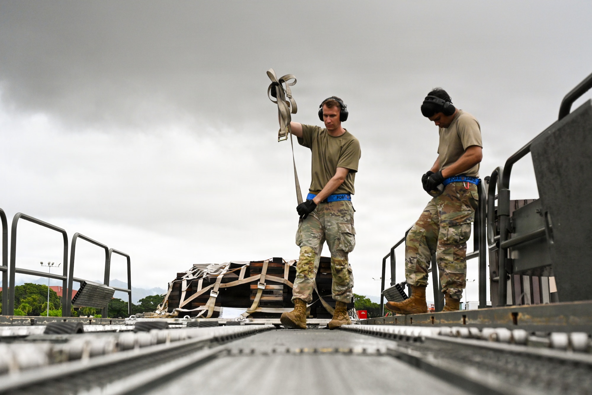 U.S. Air Force Tech. Sgt. Thomas Schomburg, 734th Air Mobility Squadron aircraft service technician, unravels a ratchet strap during the 2026 Mobility Vanguard Rodeo on Joint Base Pearl Harbor-Hickam, Hawaii, March 12, 2026. The 734 AMS was one of 13 teams competing across two career fields in 13 different scenarios, aimed to improve readiness and interoperability across the 515th Air Mobility Operations Wing. (U.S. Air Force courtesy photo)