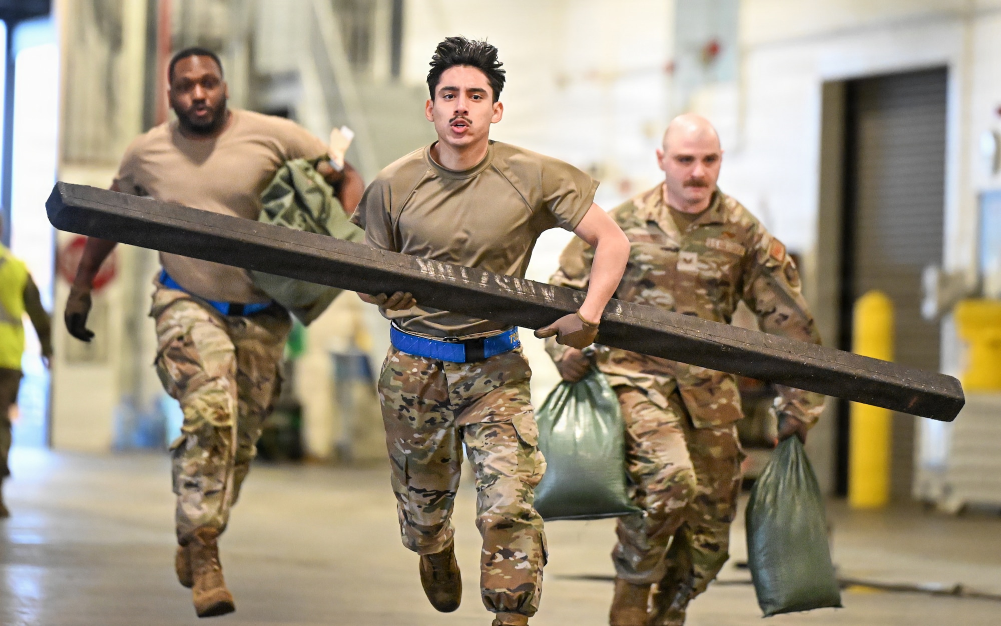 U.S. Air Force Senior Airman Alexis Contreras, 732nd Air Mobility Squadron air transportation specialist, carries a log during a combat fitness course as part of the 2026 Mobility Vanguard Rodeo on Joint Base Pearl Harbor-Hickam, Hawaii, March 13, 2026. MVR assembled 65 Airmen across 13 units to compete in different scenarios, aimed to improve readiness and interoperability across the 515th Air Mobility Operations Wing. (U.S. Air Force courtesy photo)