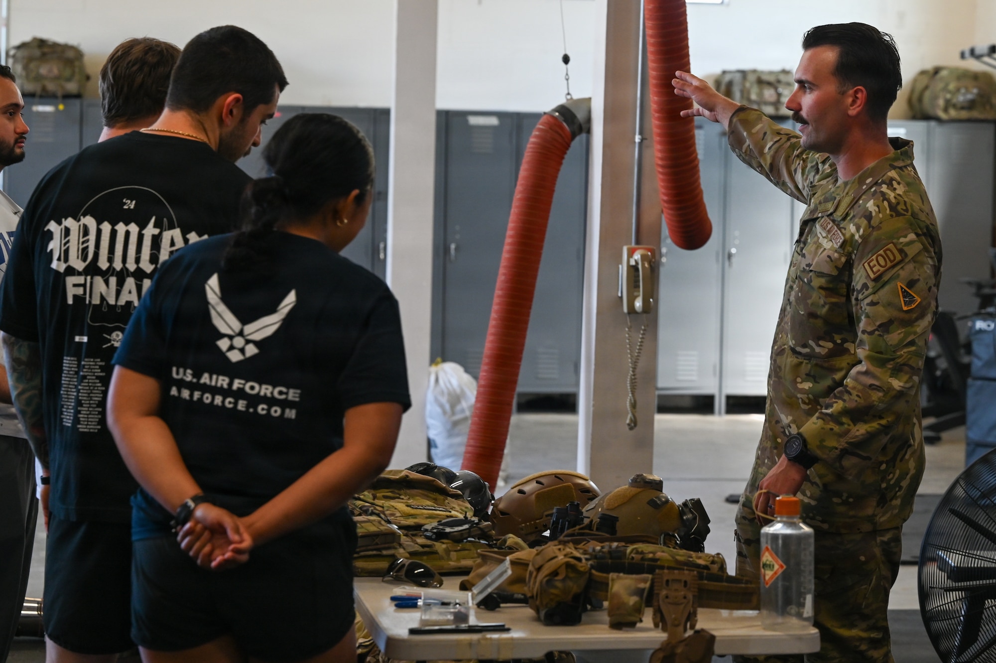 U.S. Air Force Senior Airman Dylan Hughes, 30th Civil Engineer Squadron Explosive Ordnance Disposal technician, showcases EOD equipment and talks to standing delayed entry program candidates.