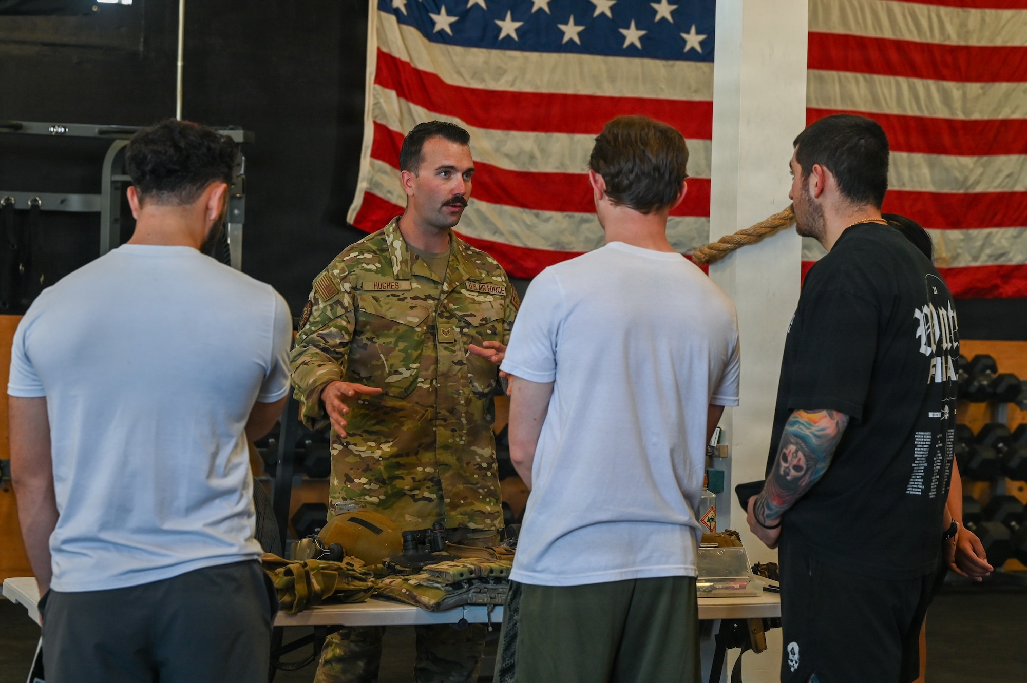 U.S. Air Force Senior Airman Dylan Hughes, 30th Civil Engineer Squadron Explosive Ordnance Disposal technician, showcases EOD equipment and talks to standing delayed entry program candidates.