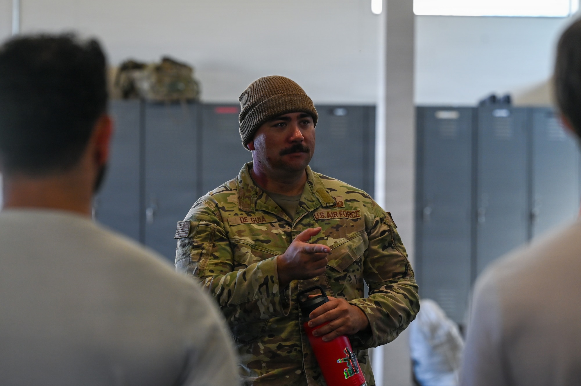 U.S. Air Force Tech. Sgt. Charles de Guia, 30th Civil Engineer Squadron Explosive Ordnance Disposal logistics noncommissioned officer in charge, speaks to delayed entry program candidates.
