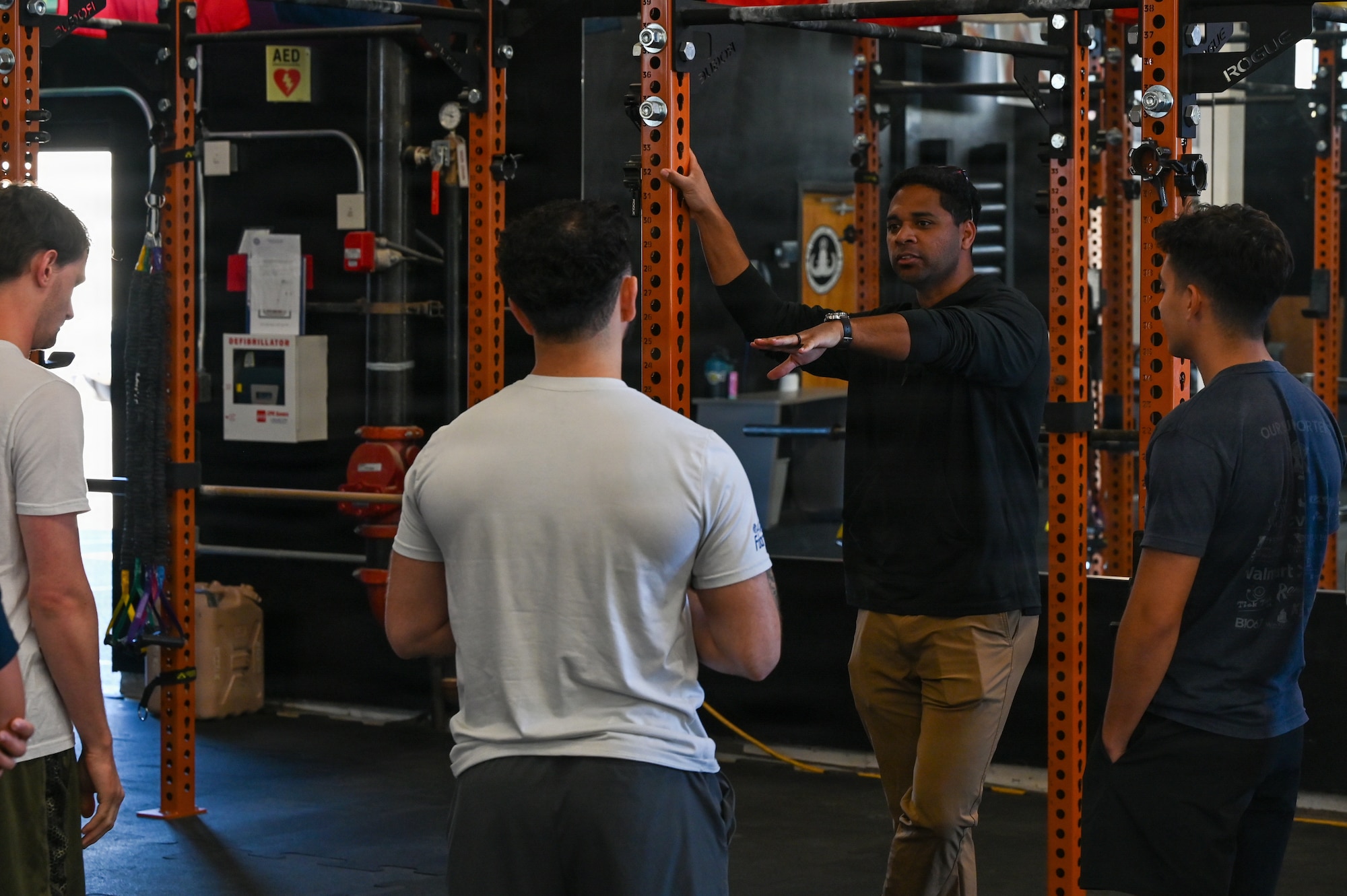 U.S. Air Force Tech. Sgt. Anthony Griffin, Air Force Special Warfare scout, speaks to candidates of the Delayed Entry Program inside a gym.