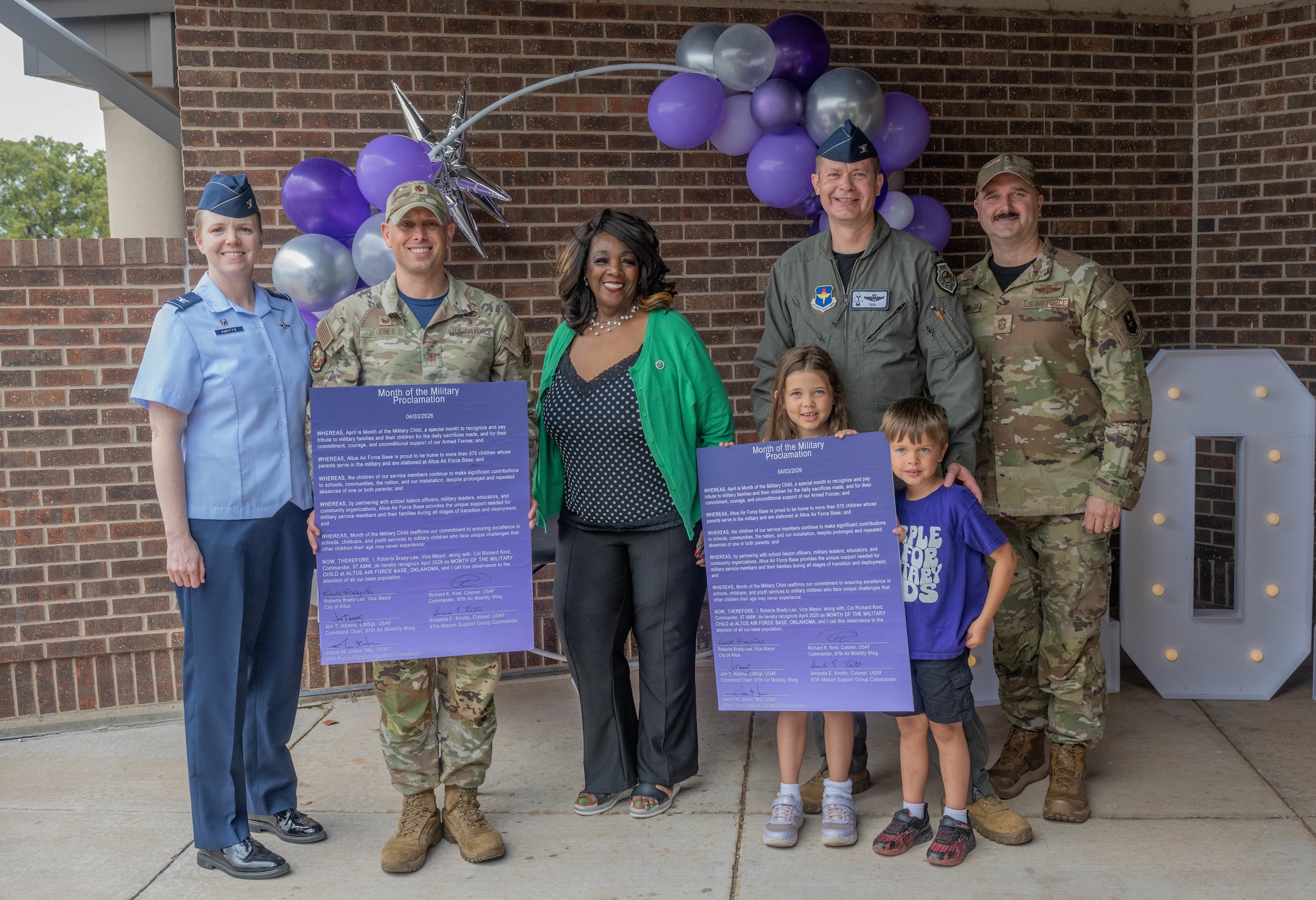 Altus Air Force Base (AFB) leadership and Altus Vice Mayor Roberta Brady-Lee hold a signed proclamation to honor the Month of the Military Child at Altus AFB, Oklahoma, April 3, 2026. The vice mayor and Altus AFB leadership signed a proclamation and held a celebratory parade at the Child Development Center to honor the resilience, strength and sacrifices of military children. (U.S. Air Force photo by Airman 1st Class Emma Wright)