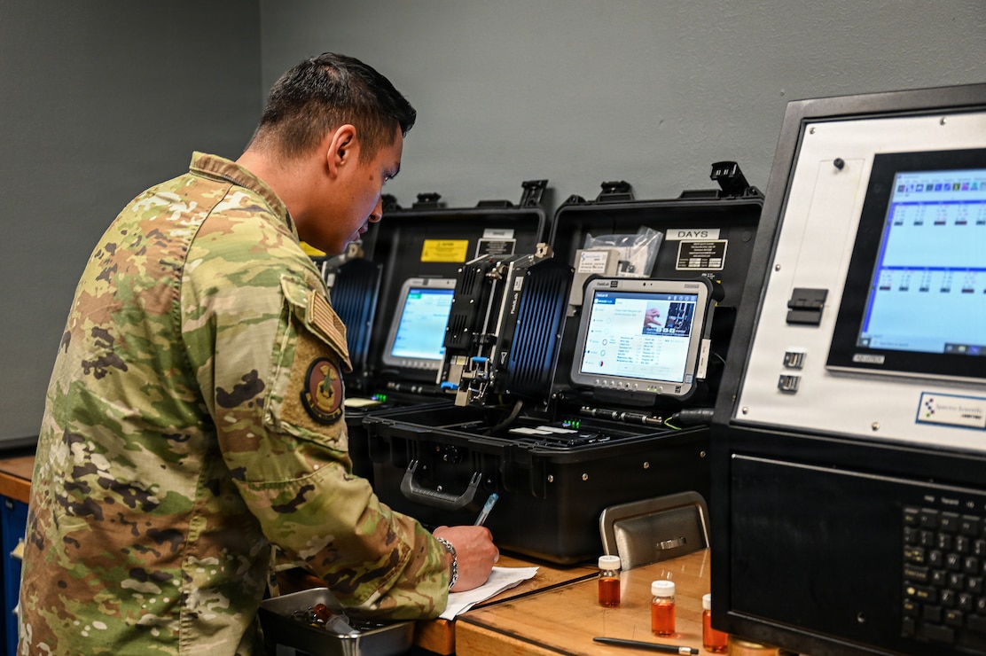 An Airman records oil sample data.