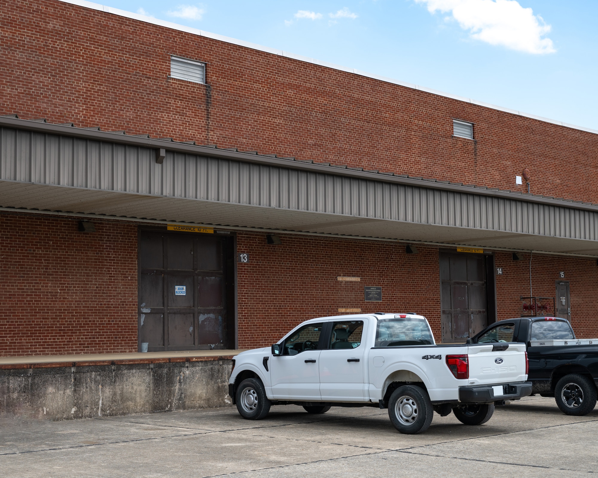 President Harry S. Truman inaugurates Arnold Air Force Base in 1951, speaking from the platform of its very first building. Seventy-five years later, this historic structure continues to serve as a crucial logistics hub for the vastly expanded base. (U.S. Air Force photo by Keith Thornburgh)