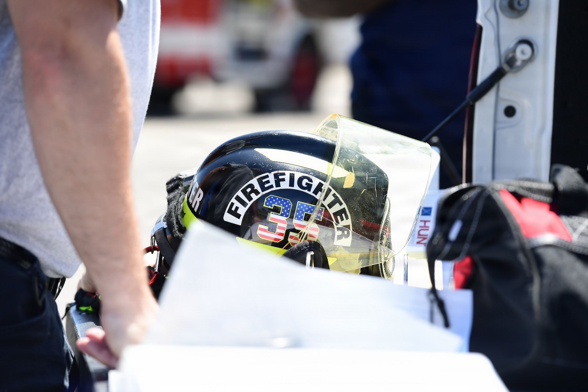 A firefighter helmet sits on a truck tailgate.
