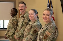Four military members pose for a photo