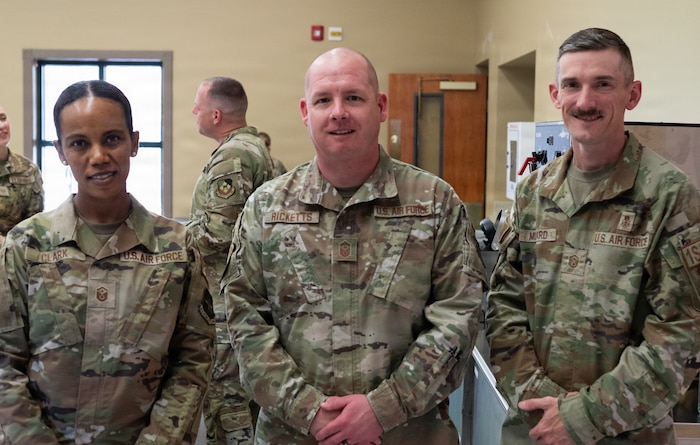Three military members pose for a photo