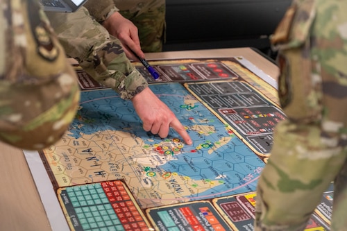 Airman Leadership School students work through a strategic exercise at the Elmendorf Professional Military Education Center on Joint Base Elmendorf-Richardson, Alaska, March 27, 2026. These scenarios challenge Airmen to apply their technical expertise to complex logistics and security problems specific to the Pacific region, bridging the gap between daily tasks and global theater requirements. (U.S. Air Force photo by Airman 1st Class Theodore Gowdy)