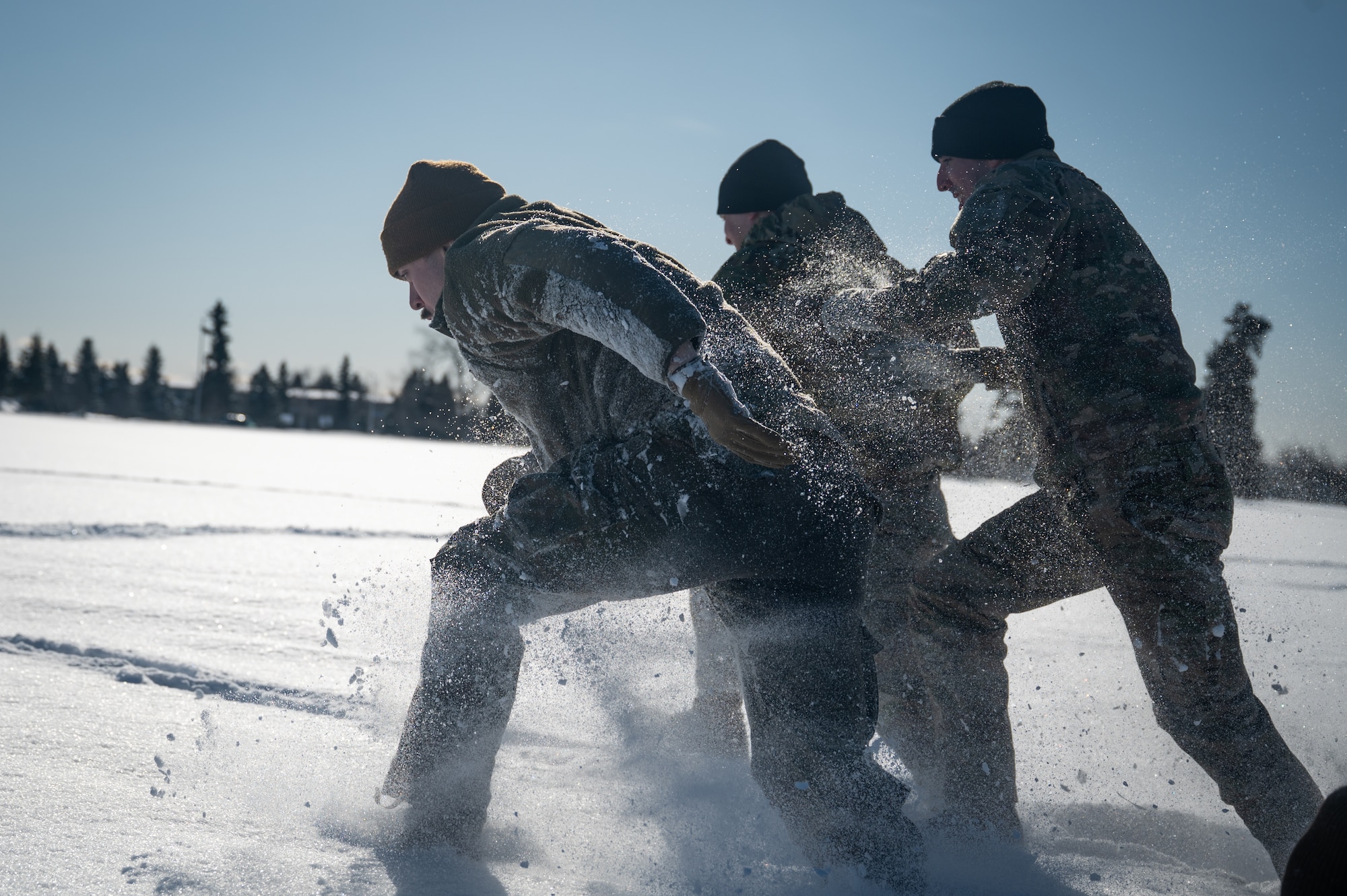 U.S. Air Force Airman Leadership School students bound through the snow during the Combat Fitness Experience at the Elmendorf Professional Military Education Center on Joint Base Elmendorf Richardson, Alaska, March 9, 2026. The PME curriculum integrates these functional movements to ensure future front-line supervisors possess the physical conditioning and muscle memory required for high-intensity, deployed environments. (U.S. Air Force photo by Airman 1st Class Theodore Gowdy)