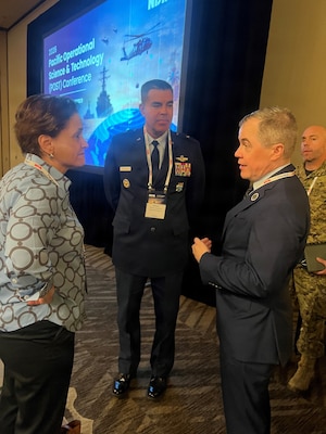 U.S. Indo-Pacific Command J7 (Training and Exercise) Director, Brig. Gen. Richard Goodman (center) and Andrew Merz, J7 Director of Staff, speak with a participant at the Pacific Operation Science & Technology Conference in Waikiki, March 10, 2026, following a breakout session on multi-domain training experimentation.