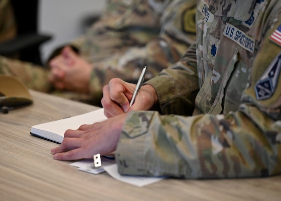 U.S. Space Force Lt. Col. Benton Enomoto, SPACEFOR-SOUTH acting deputy commander, takes notes during a meeting with representatives from the University of Arizona’s Kyl Institute for National Security, in Tucson, Arizona, April 2, 2026. This nonprofit engagement is part of ongoing efforts to strengthen relationships with space research programs and deliberately develop Guardians through existing research while expanding partnership opportunities with Latin America. (U.S. Air Force photo by Staff Sgt. Abbey Rieves)