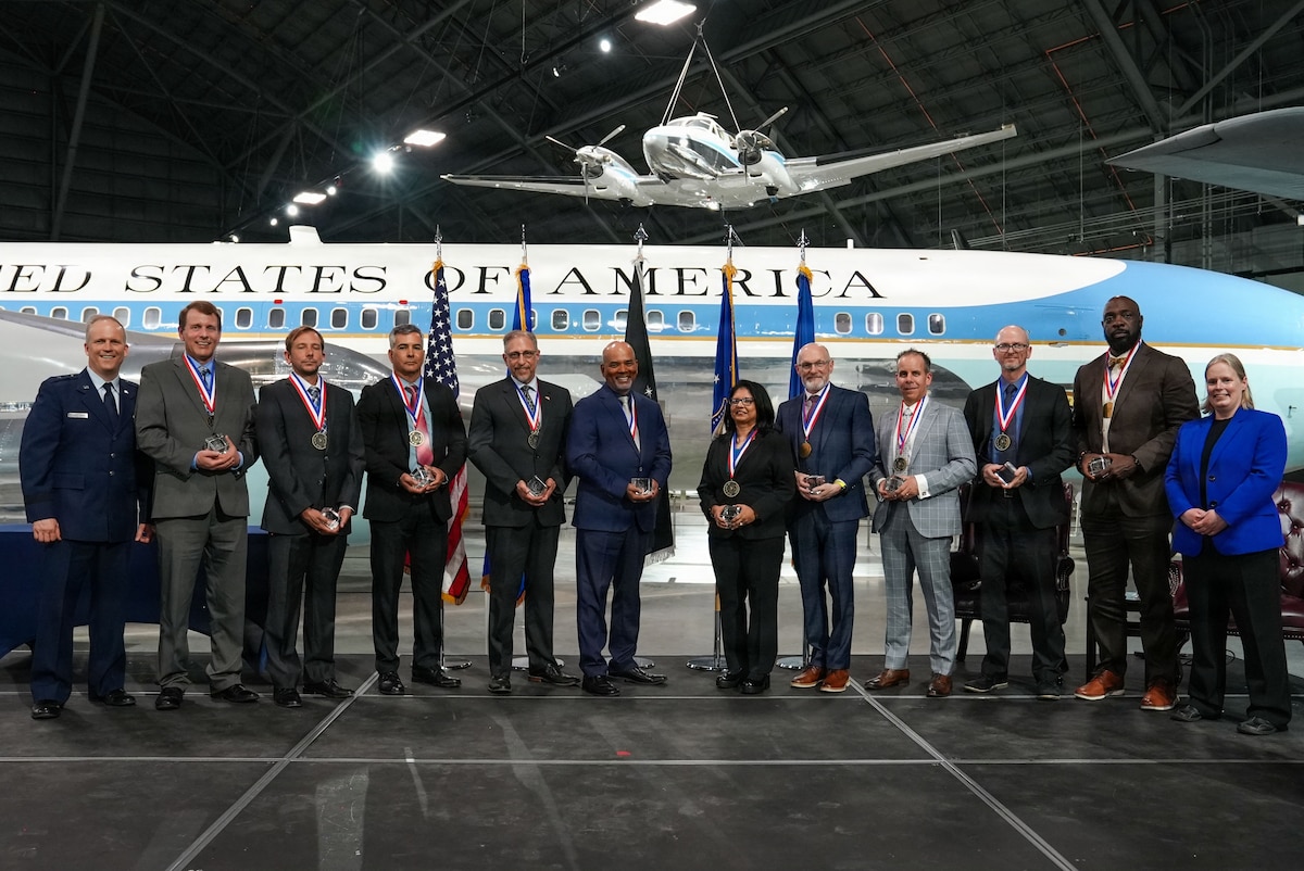 Photo of all ten AFRL Fellow recipients standing with both AFRL Commander Brig. Gen. Jason Bartolomei and AFRL Chief Technology Officer Dr. Kath-Anne Soderberg.