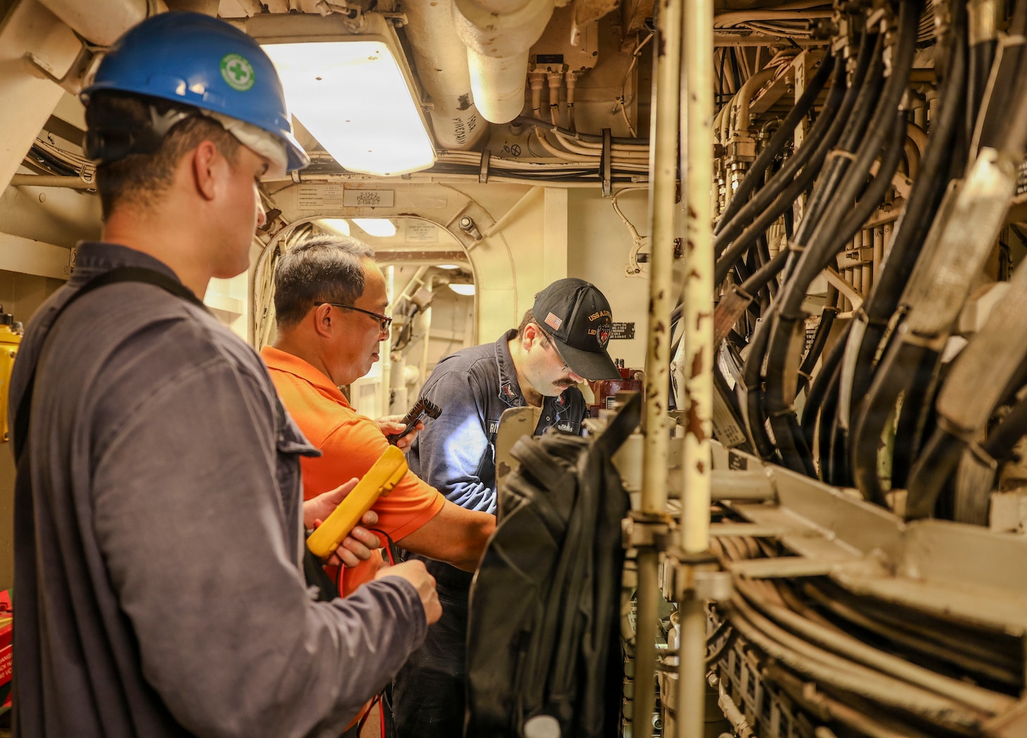 A Philippine Navy contractor works with Electrician’s Mate 2nd Class Chase Bohan, left, assigned to Southwest Regional Maintenance Center, and Electrician’s Mate 2nd Class Wyatt Rimmer, assigned to Whidbey Island-class dock landing ship USS Ashland (LSD 48), as they perform maintenance on valves as part of ship wartime repair and maintenance exercise (SWARMEX) in Cebu, Philippines, March 25, 2026.