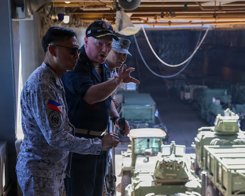 Cmdr. Adam Peeples, commanding officer of Whidbey Island-class dock landing ship USS Ashland (LSD 48) [right], speaks to Philippine Navy Rear Adm. Juario C. Marayag, Commander, Naval Sea Systems Command, about well deck operations during a visit to the ship, as part of ship wartime repair and maintenance exercise (SWARMEX) in Cebu, Philippines, March 25, 2026.