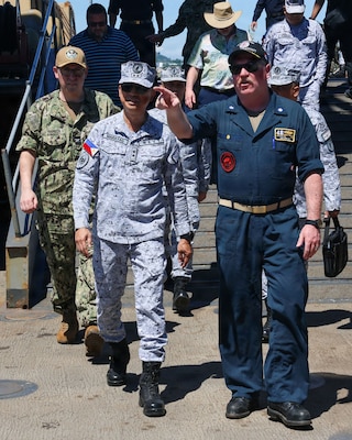 Cmdr. Adam Peeples, commanding officer of Whidbey Island-class dock landing ship USS Ashland (LSD 48) [right], speaks to Philippine Navy Rear Adm. Juario C. Marayag, Commander, Naval Sea Systems Command, during a visit to the ship as part of ship wartime repair and maintenance exercise (SWARMEX) in Cebu, Philippines, March 25, 2026.