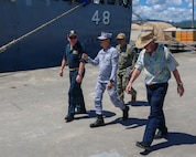 Cmdr. Adam Peeples, commanding officer of Whidbey Island-class dock landing ship USS Ashland (LSD 48) [left], walks with Philippine Navy Rear Adm. Juario C. Marayag, Commander, Naval Sea Systems Command [center], during a visit as part of ship wartime repair and maintenance exercise (SWARMEX) in Cebu, Philippines, March 25, 2026.