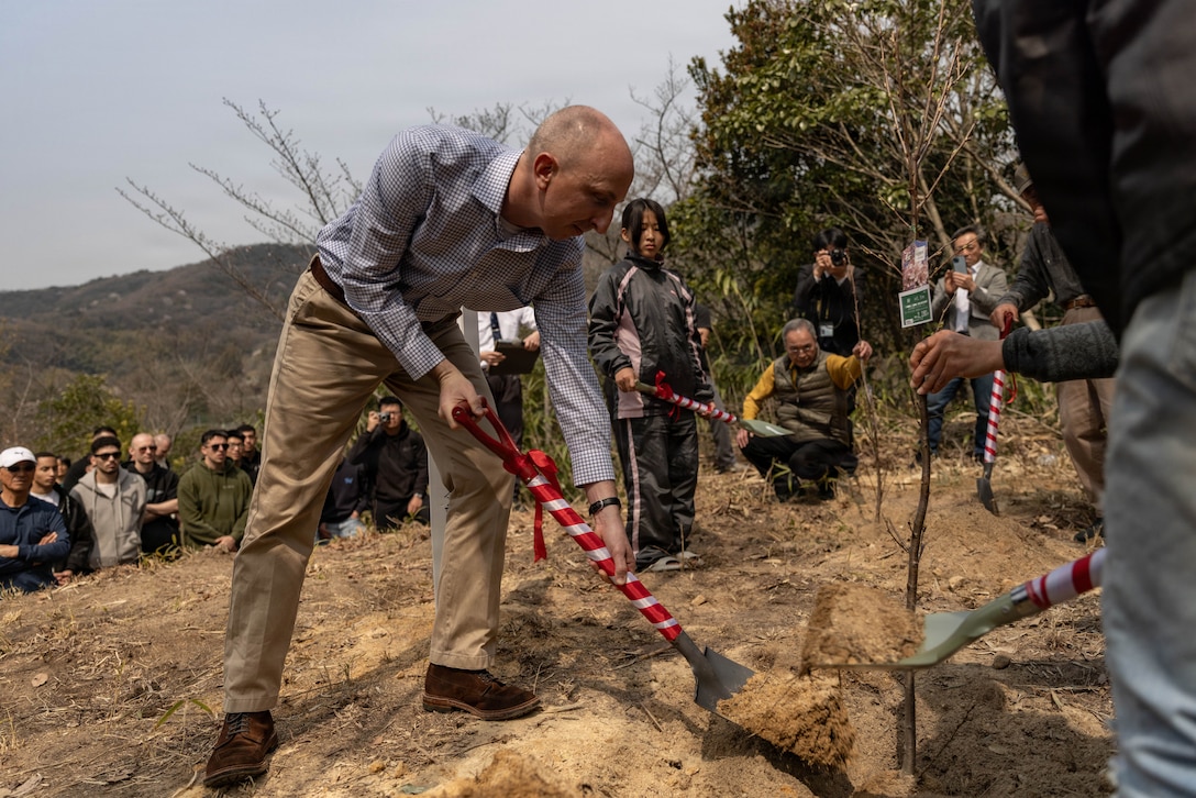 U.S. Marine Corps Maj. Matthew Forshee, the future operations officer with Headquarters and Headquarters Squadron (HHS), Marine Corps Air Station Iwakuni and a native of Texas, plants a cherry tree during the 81st anniversary of the Marukoyama Memorial Ceremony in Kure City, Hiroshima Prefecture, Japan, March. 28, 2026. The Marukoyama Memorial Ceremony is held every year in Kure during cherry blossom season to honor the crew members of the U.S. Navy TBM-3 Avenger, Torpedo Squadron 6, who died in Kure City, Hiroshima Prefecture, Japan, on July 24, 1945. (U.S. Marine Corps photo by Lance Cpl. Isaac De Leon)